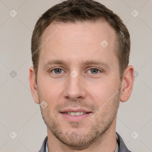 Joyful white young-adult male with short  brown hair and grey eyes