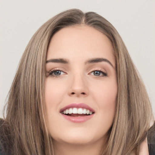 Joyful white young-adult female with long  brown hair and brown eyes