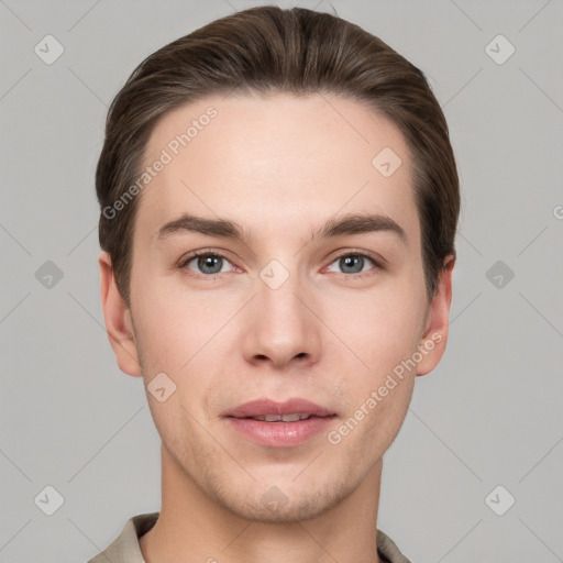 Joyful white young-adult male with short  brown hair and grey eyes