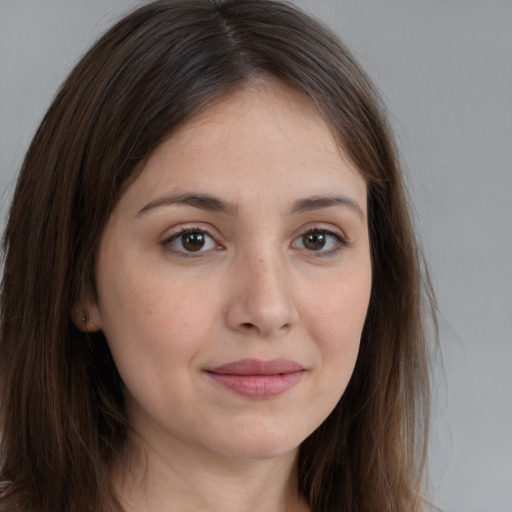 Joyful white young-adult female with long  brown hair and brown eyes