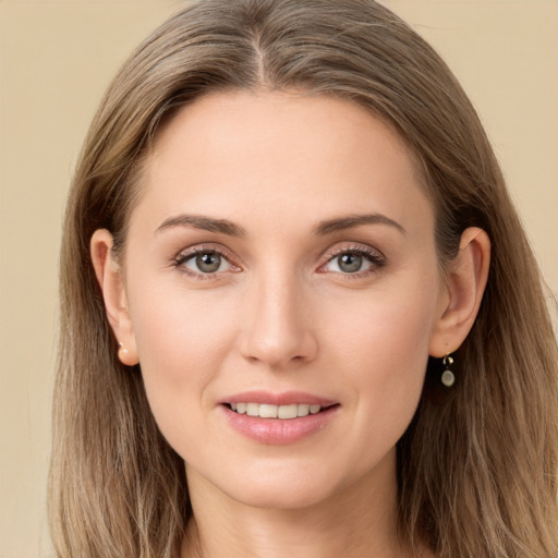 Joyful white young-adult female with long  brown hair and grey eyes