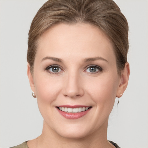 Joyful white young-adult female with short  brown hair and grey eyes