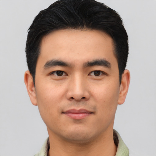 Joyful asian young-adult male with short  black hair and brown eyes