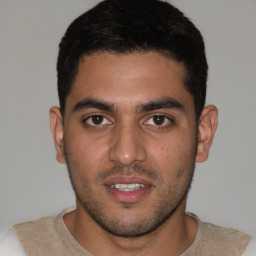 Joyful white young-adult male with short  black hair and brown eyes