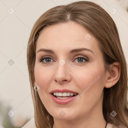 Joyful white young-adult female with long  brown hair and grey eyes