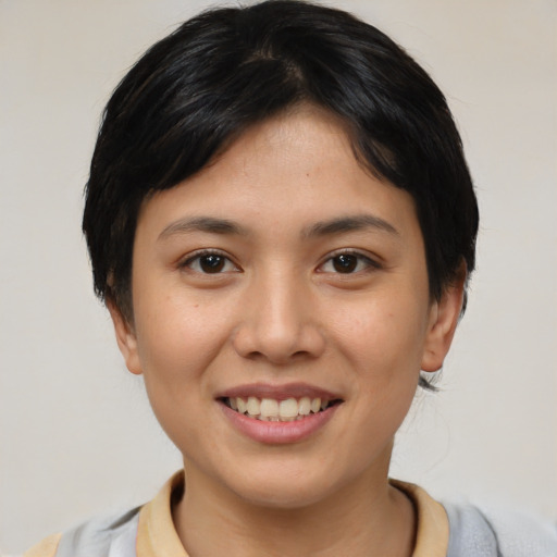 Joyful asian young-adult female with short  brown hair and brown eyes