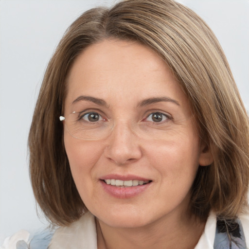 Joyful white adult female with medium  brown hair and grey eyes