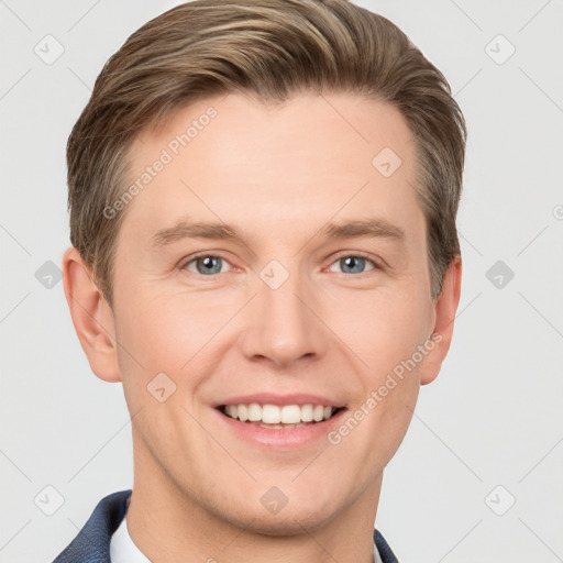 Joyful white young-adult male with short  brown hair and grey eyes