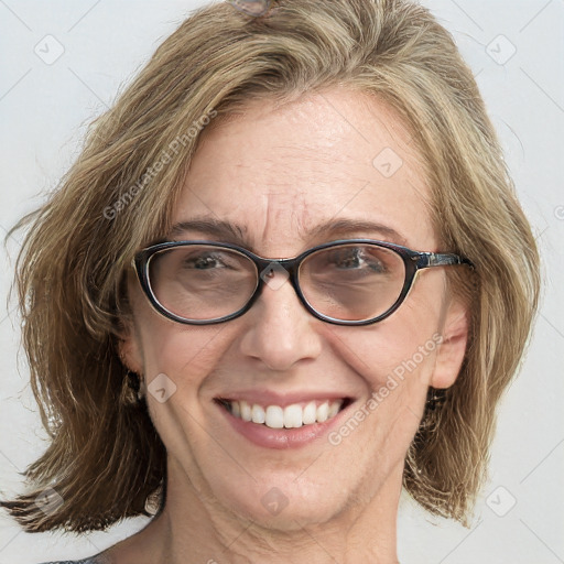 Joyful white adult female with medium  brown hair and blue eyes