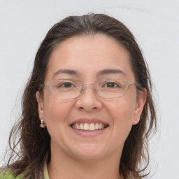 Joyful white adult female with long  brown hair and brown eyes