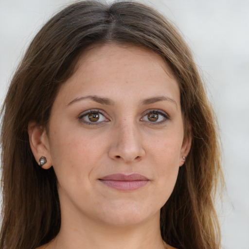 Joyful white young-adult female with long  brown hair and green eyes