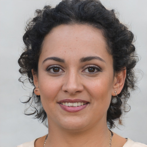 Joyful latino young-adult female with medium  brown hair and brown eyes