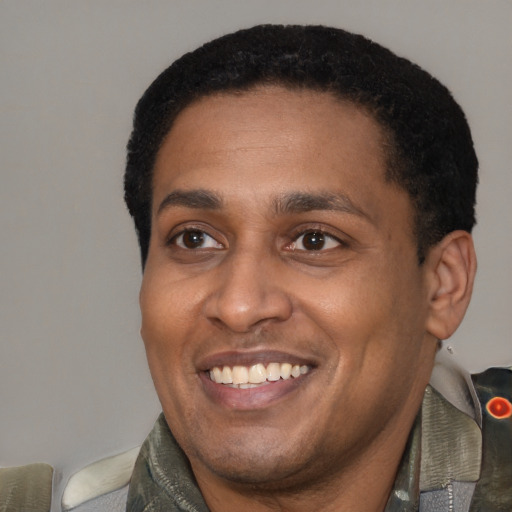 Joyful latino adult male with short  black hair and brown eyes