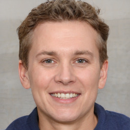 Joyful white adult male with short  brown hair and grey eyes