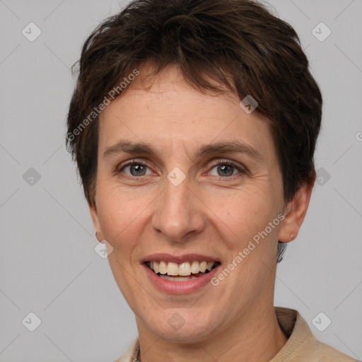 Joyful white adult female with short  brown hair and grey eyes