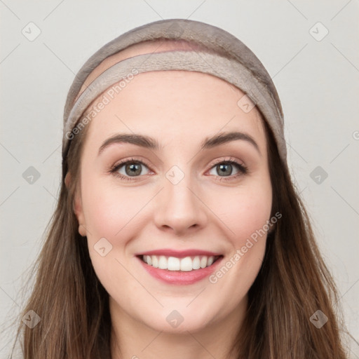 Joyful white young-adult female with long  brown hair and grey eyes