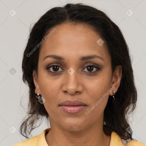 Joyful black adult female with medium  brown hair and brown eyes