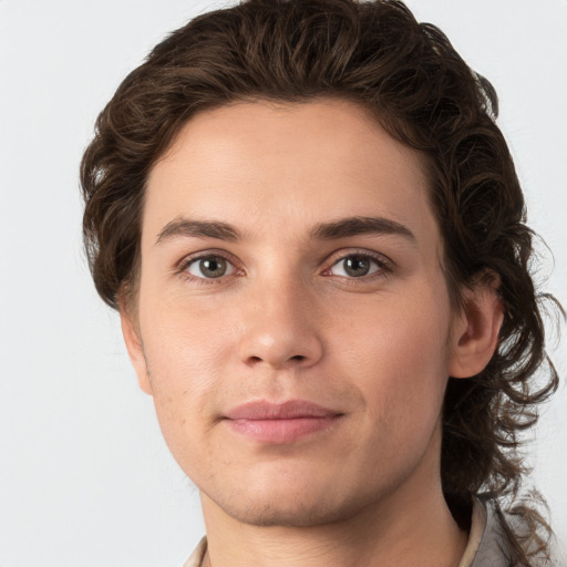 Joyful white young-adult male with medium  brown hair and grey eyes