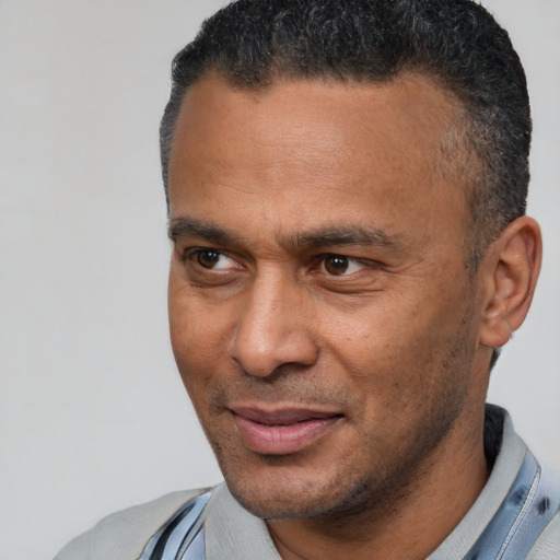 Joyful latino adult male with short  brown hair and brown eyes
