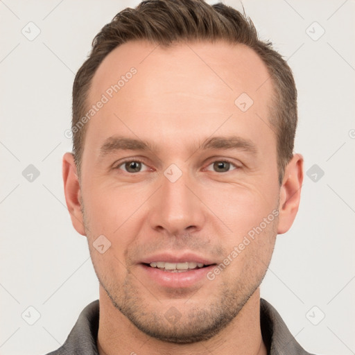 Joyful white young-adult male with short  brown hair and grey eyes