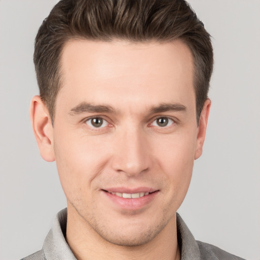 Joyful white young-adult male with short  brown hair and brown eyes