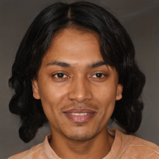 Joyful latino young-adult male with medium  black hair and brown eyes