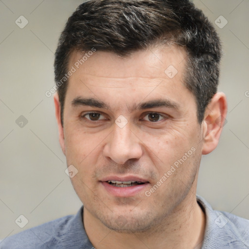 Joyful white adult male with short  black hair and brown eyes