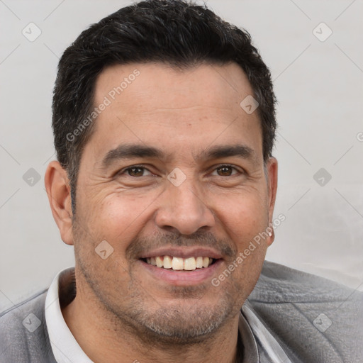 Joyful white adult male with short  brown hair and brown eyes