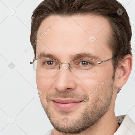 Joyful white adult male with short  brown hair and brown eyes