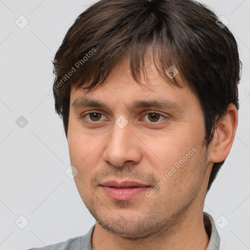 Joyful white adult male with short  brown hair and brown eyes