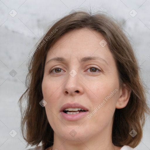 Joyful white adult female with medium  brown hair and grey eyes