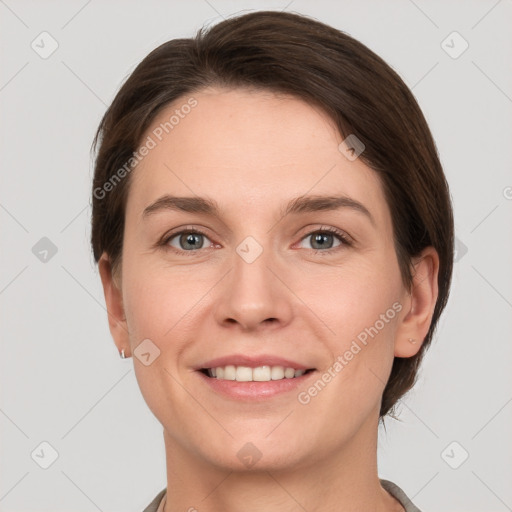 Joyful white young-adult female with short  brown hair and grey eyes