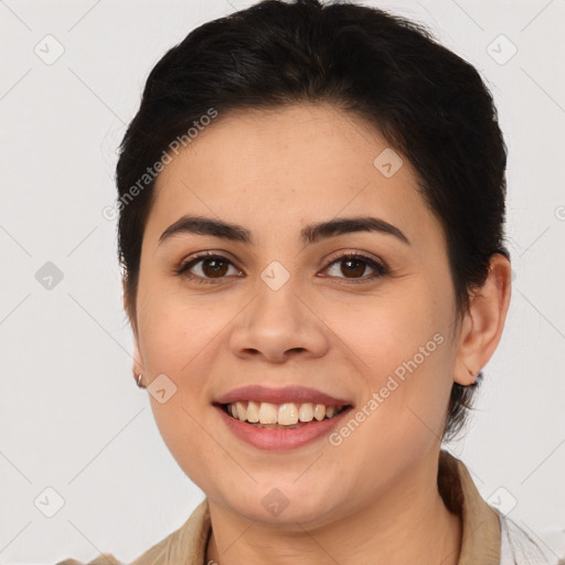 Joyful latino young-adult female with medium  brown hair and brown eyes