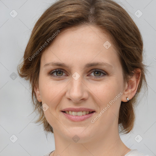 Joyful white young-adult female with medium  brown hair and green eyes