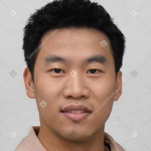 Joyful asian young-adult male with short  black hair and brown eyes