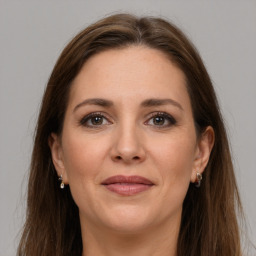 Joyful white adult female with long  brown hair and grey eyes