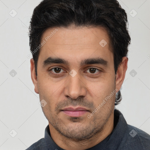 Joyful white young-adult male with short  black hair and brown eyes