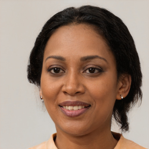 Joyful black adult female with medium  black hair and brown eyes