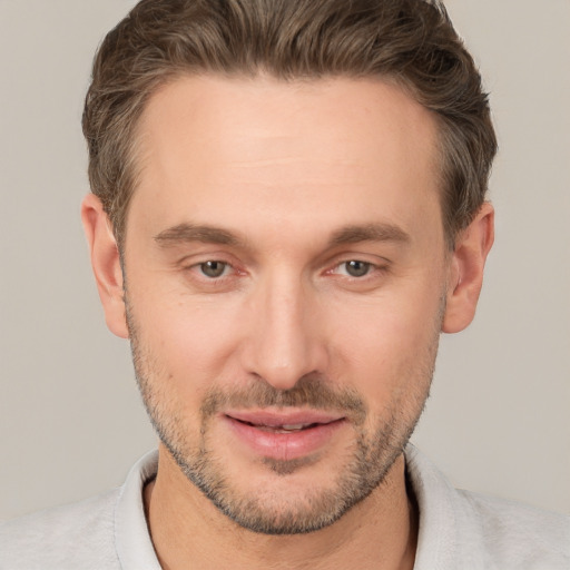 Joyful white adult male with short  brown hair and brown eyes