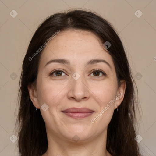 Joyful white adult female with long  brown hair and brown eyes