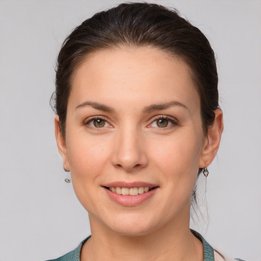 Joyful white young-adult female with medium  brown hair and grey eyes