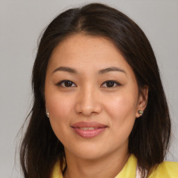 Joyful asian young-adult female with medium  brown hair and brown eyes