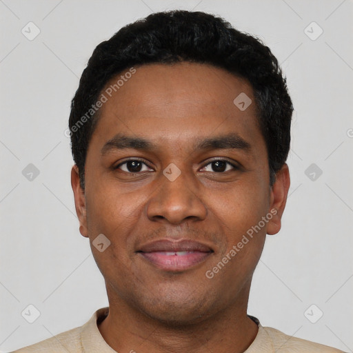 Joyful black young-adult male with short  black hair and brown eyes