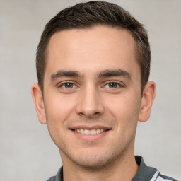 Joyful white young-adult male with short  brown hair and brown eyes