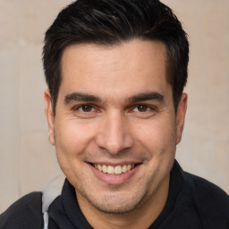 Joyful white adult male with short  brown hair and brown eyes