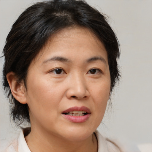 Joyful white adult female with medium  brown hair and brown eyes