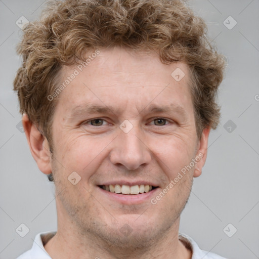 Joyful white adult male with short  brown hair and grey eyes