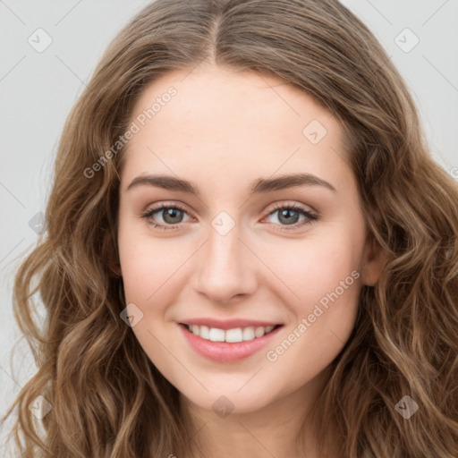 Joyful white young-adult female with long  brown hair and green eyes