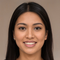 Joyful latino young-adult female with long  brown hair and brown eyes