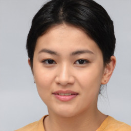 Joyful asian young-adult female with short  brown hair and brown eyes